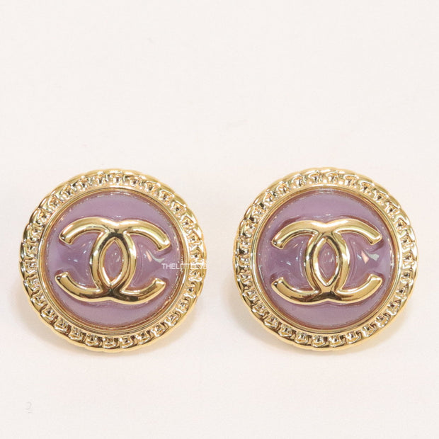 Twin C motif gold plated round studs on lilac acrylic base
