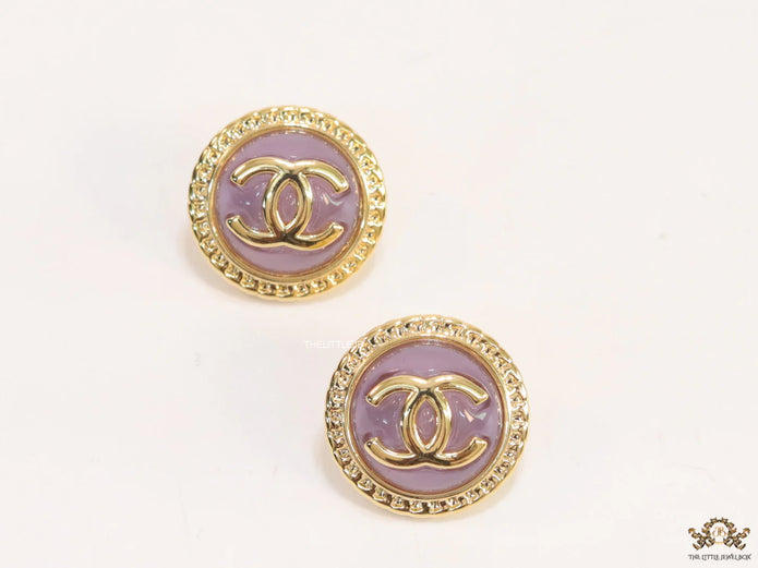 Twin C motif gold plated round studs on lilac acrylic base