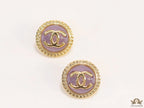 Twin C motif gold plated round studs on lilac acrylic base