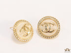 Twin C motif gold plated round studs on pearly cream acrylic base