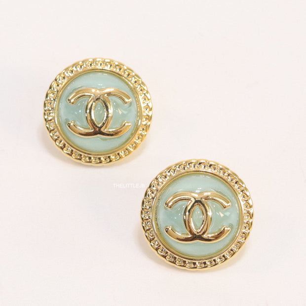 Twin C motif gold plated round studs on mint green acrylic base