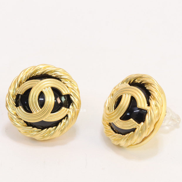 Twin C motif matt gold plated round studs on black base