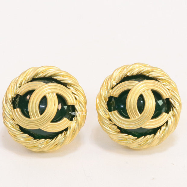 Twin C motif matt gold plated round studs on deep green base