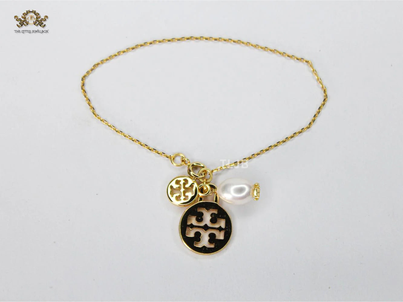 Three charm gold toned bracelet