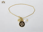 Three charm gold toned bracelet