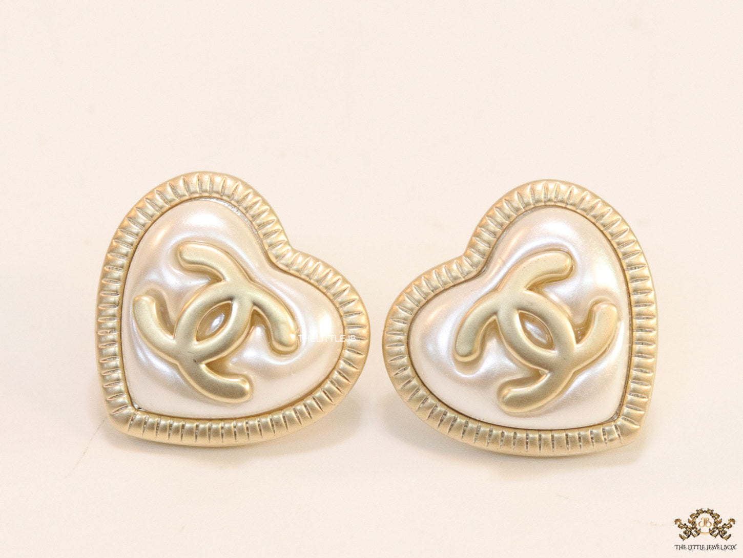 Heart shape twin C motif golden studs with pearl base