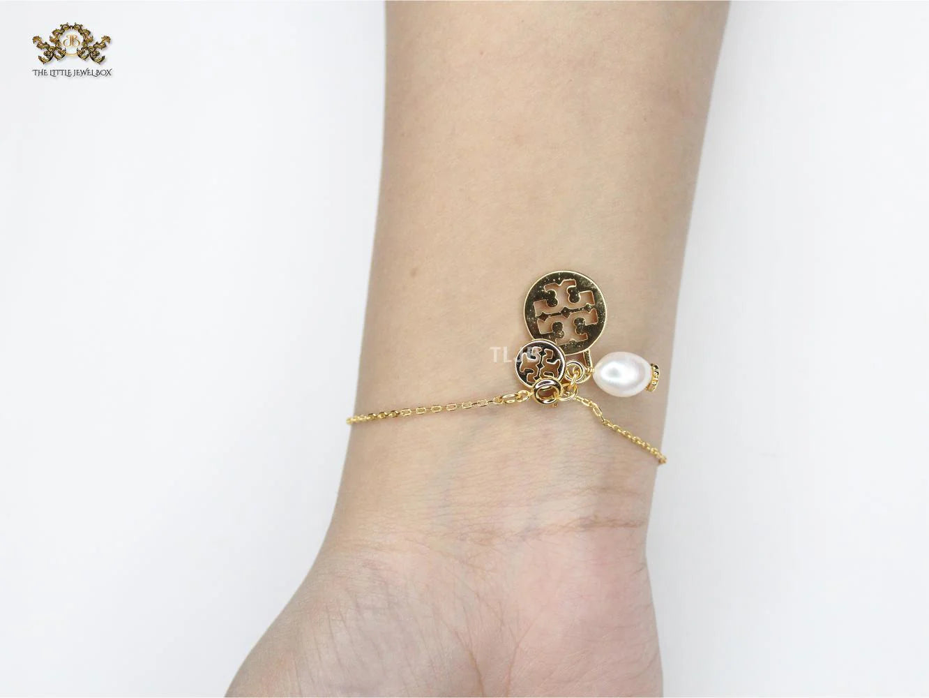 Three charm gold toned bracelet