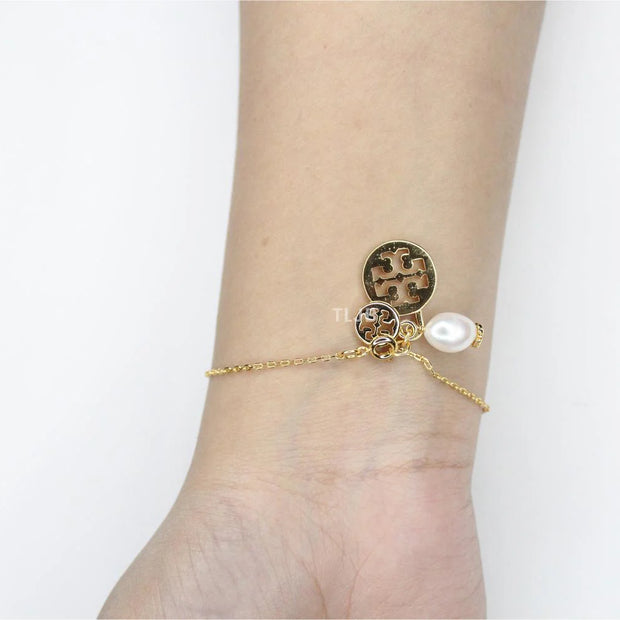 Three charm gold toned bracelet