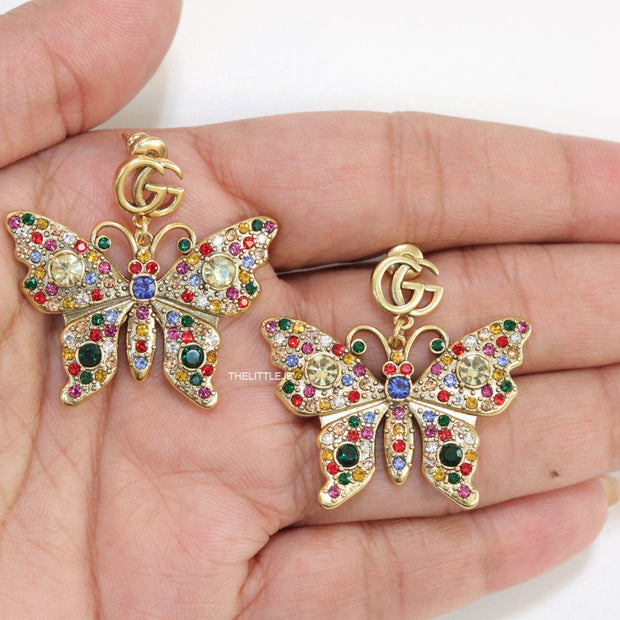 Gold plated twin G motif earrings with multi cz butterfly drops