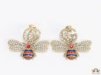 Pearl twin G earrings with pearl and multi cz bees in golden finish