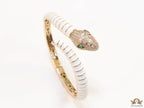 Top open serpentine bracelet in white enamel with  gold plated details and cubic zirconia stones head