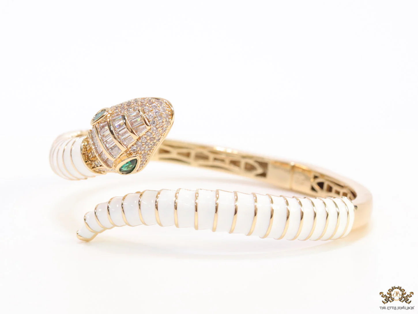 Top open serpentine bracelet in white enamel with  gold plated details and cubic zirconia stones head
