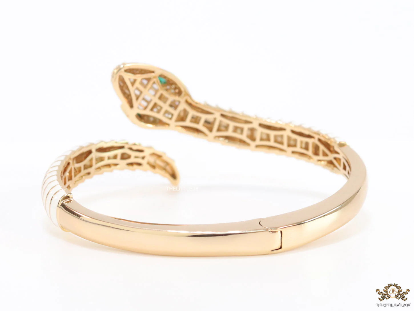 Top open serpentine bracelet in white enamel with  gold plated details and cubic zirconia stones head