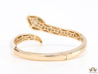 Top open serpentine bracelet in white enamel with  gold plated details and cubic zirconia stones head