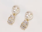 Alphabet C and D dangling stone pearl studs in platinum finish