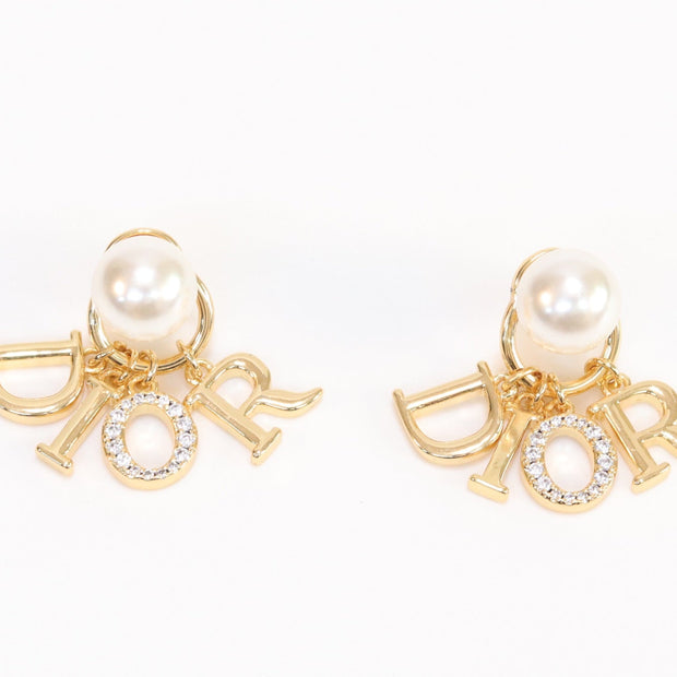 Alphabet CD dangling pearl studs in gold finish with CZ