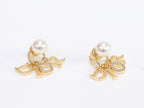 Alphabet CD dangling pearl studs in gold finish with CZ