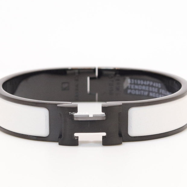 Premium collection band style bracelet in matt white with black metallic details and black T alphabet motif