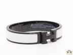 Premium collection band style bracelet in matt white with black metallic details and black T alphabet motif