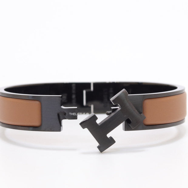 Premium collection band style bracelet in matt tan with black metallic details and black T alphabet motif
