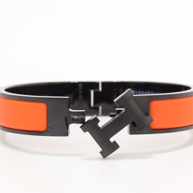 Premium collection band style bracelet in matt orange with black metallic details and black T alphabet motif