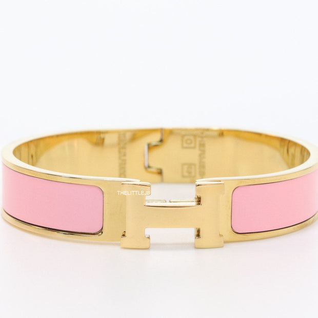Premium range band style bracelet in pink colour with gold plated metallic details and gold plated T alphabet motif