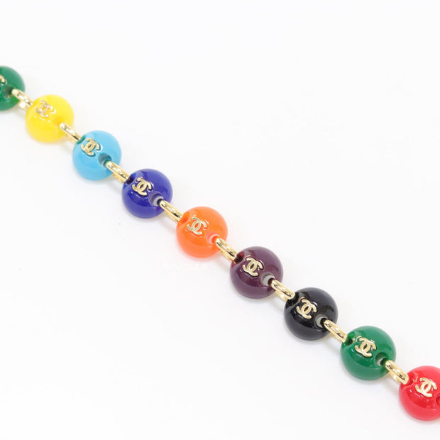 Gold plated link chain bracelet with multi coloured acrylic buttons with gold plated twin C alphabet