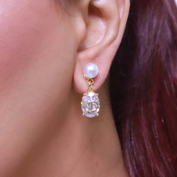 Alphabet C and D dangling stone pearl studs in platinum finish