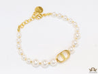 White pearl bracelet with gold plated alphabet motif