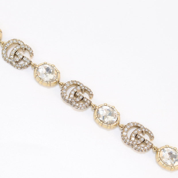 Gold plated linked chain bracelet with gold plated cubic zirconia stones twin G alphabet motifs and gold plated cubic zirconia stones