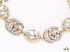 Gold plated linked chain bracelet with gold plated cubic zirconia stones twin G alphabet motifs and gold plated cubic zirconia stones