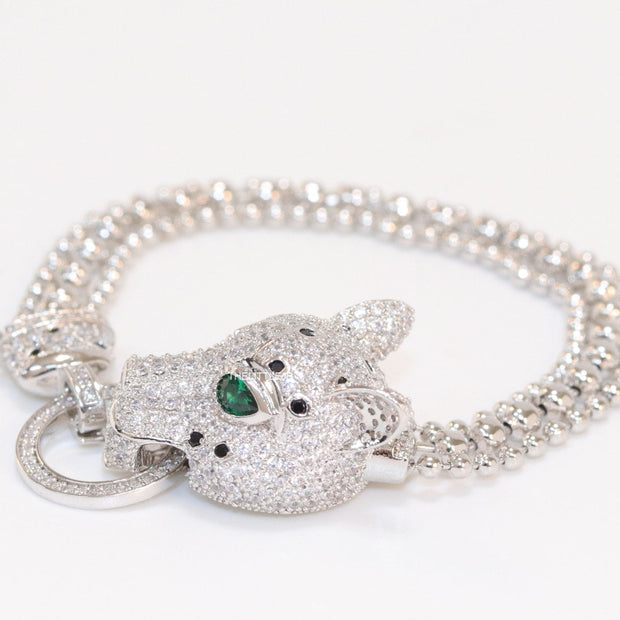 Platinum plated bracelet with cubic zirconia stones panther face motif with green cubic zirconia stone details and cubic zirconia stones disc