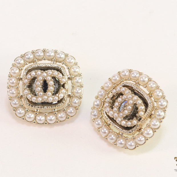 Pearl and cz studs with twin C motif