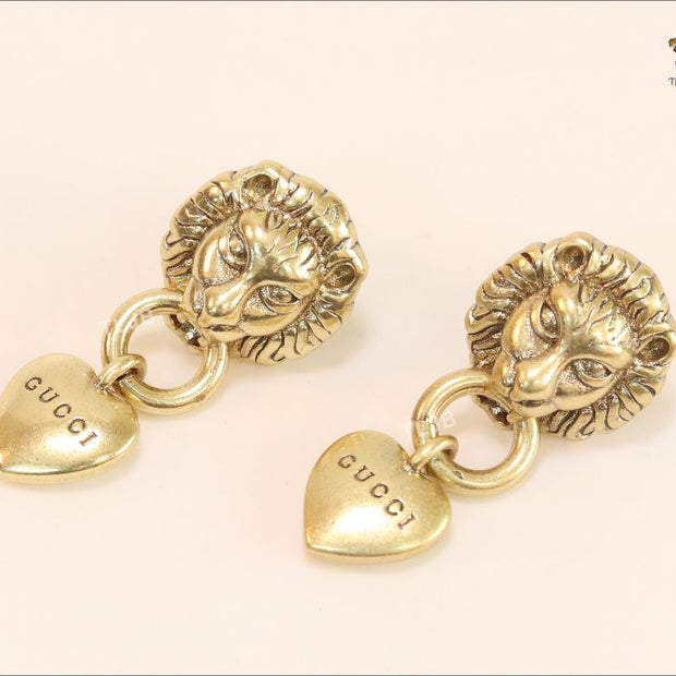 Antique lion face heart dangles