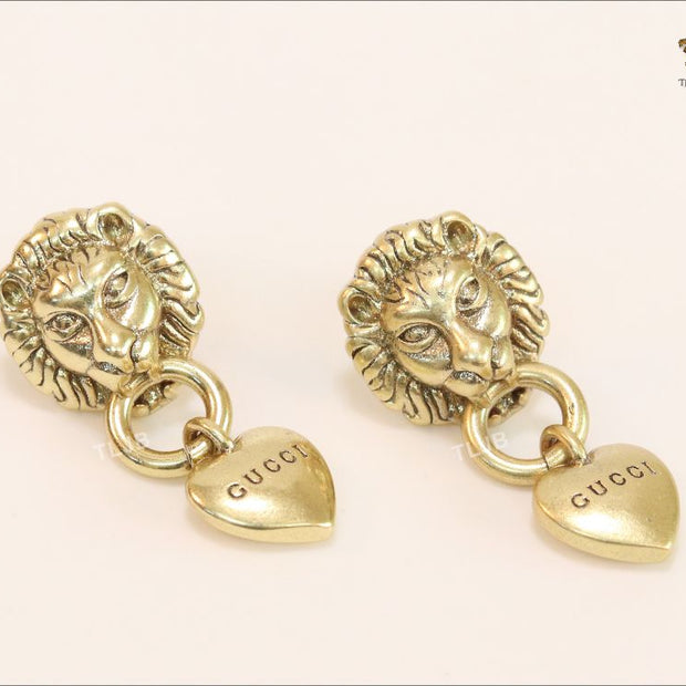 Antique lion face heart dangles