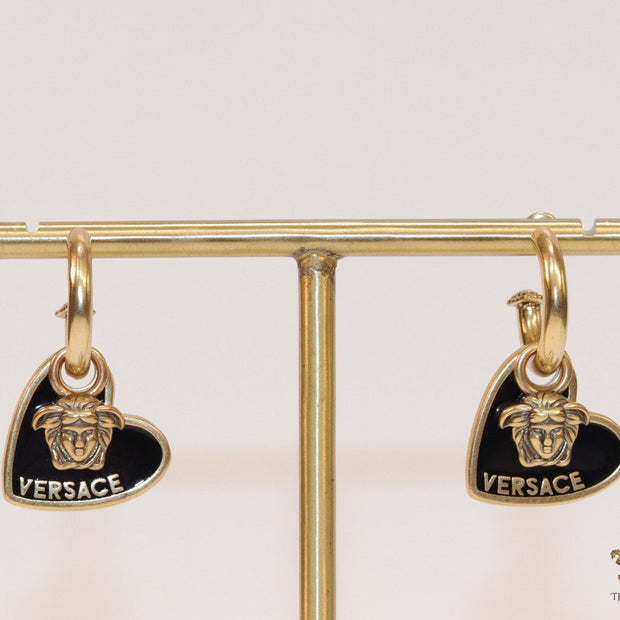 Golden and black enamel heart shape medusa earrings