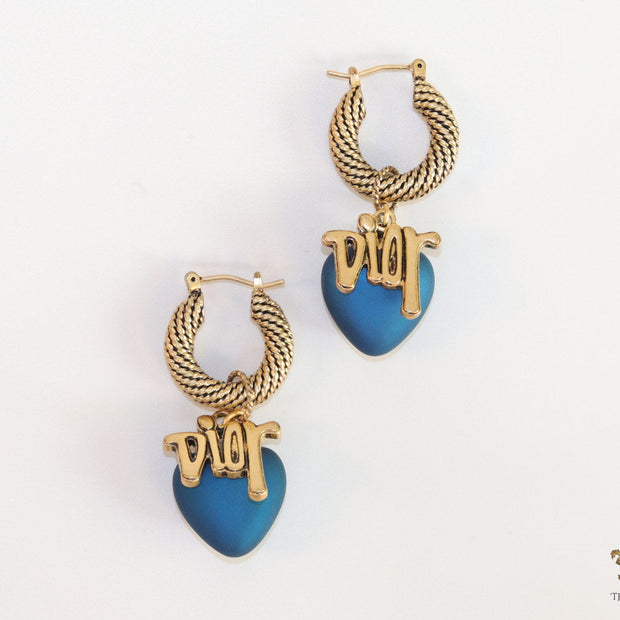 Golden hoops with alphabets and blue pearl drop