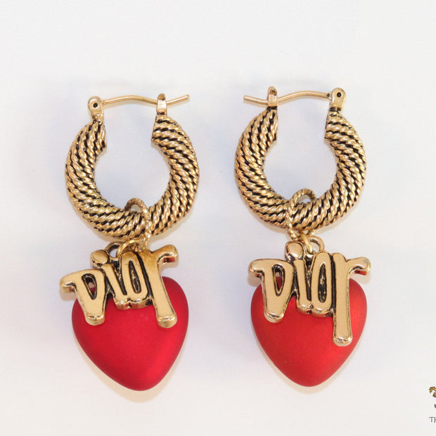 Golden hoops with alphabets and red pearl drop