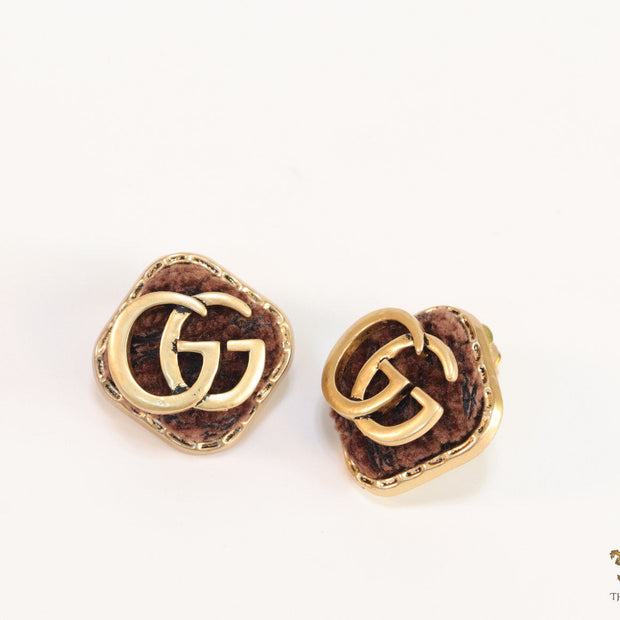 Brown velvet fur studs with golden twin G motif