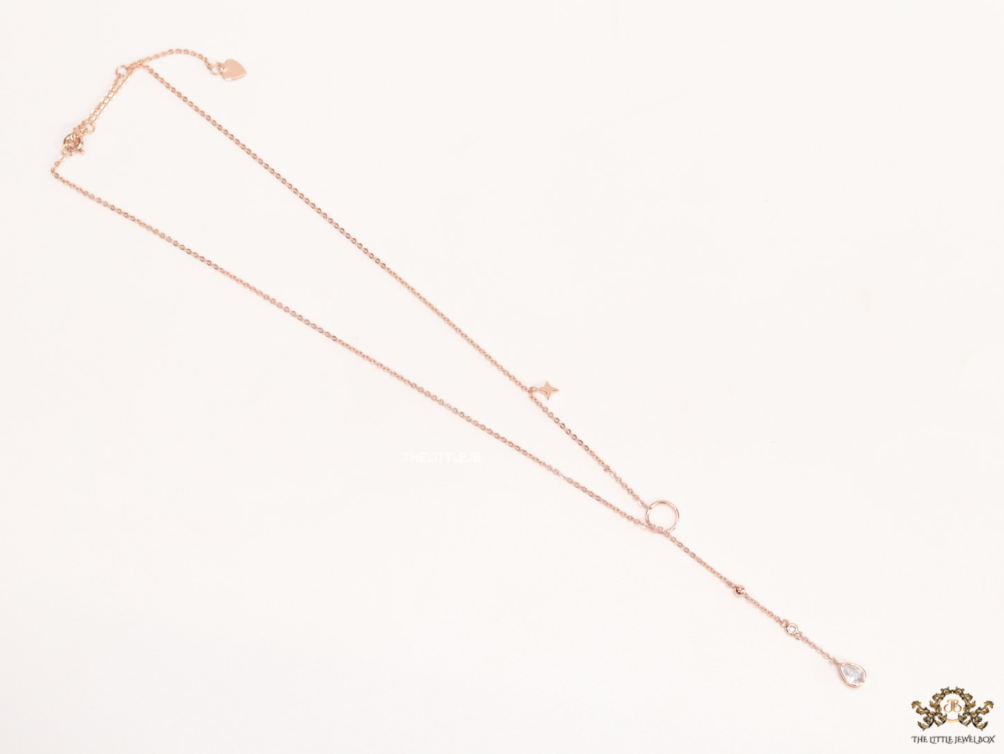 rose gold knot necklace with cz drop and small charms