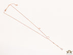 rose gold knot necklace with cz drop and small charms