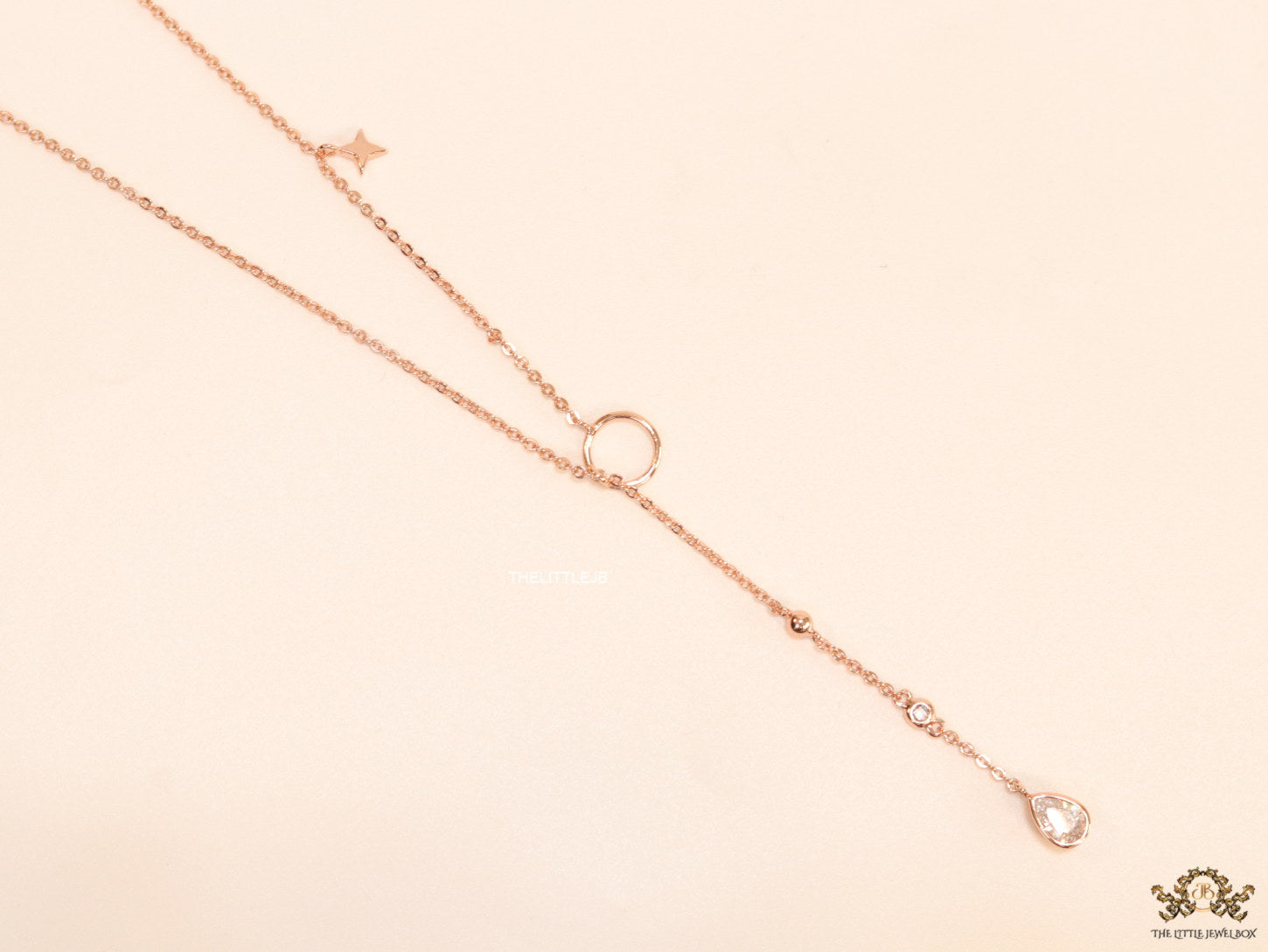 rose gold knot necklace with cz drop and small charms