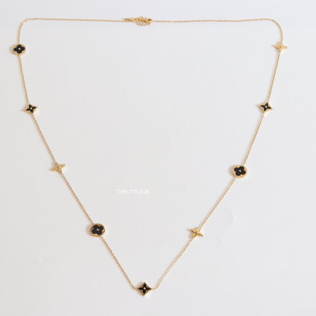 Golden chain necklace with black enamel clovers