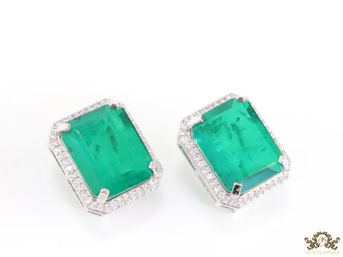 Platinum plated studs with emerald green doublet stone and white cubic zirconia stones lining
