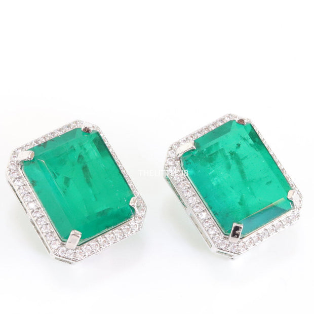 Platinum plated studs with emerald green doublet stone and white cubic zirconia stones lining