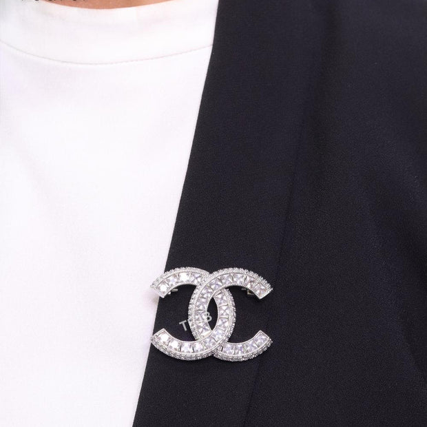 Platinum plated twin C brooch with fancy cut cz