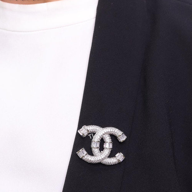 Platinum plated twin C brooch with cz baguettes