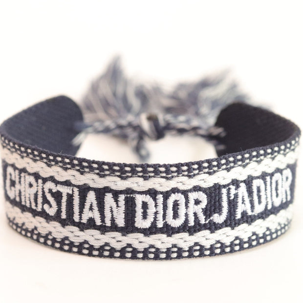 Adjustable dark grey woven bracelet with knitted alphabets and tassels