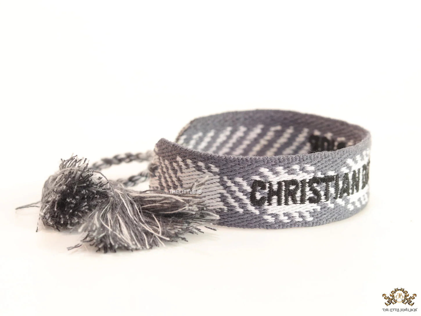 Woven grey bracelet band with black knitted alphabets