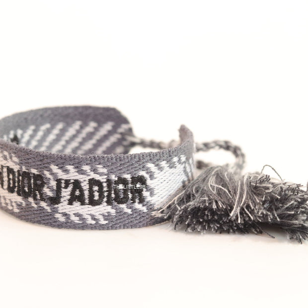 Woven grey bracelet band with black knitted alphabets